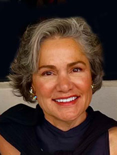 A headshot of Christina Shorall in a black shirt against a white and black background.