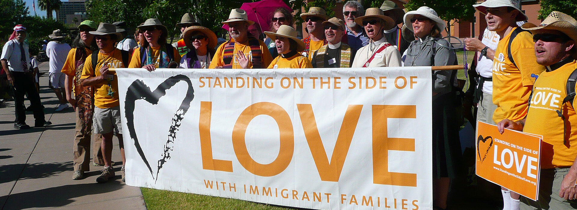 Congregants holding Standing on the Side of Love banner