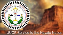 Great Seal of the Navajo Nation overlaid on blurred image of red sandstone mesas | UUCP Service to the Navajo Nation