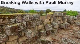 Black text: Breaking Walls with Pauli Murray overlaid on image of old stone wall with fallen blocks, green pasture in background