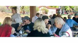 A gathering of UUCP folks snacking at a picnic table.