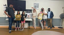 A group of UUCP kids posing for a photo in a classroom