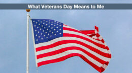 An American flag with clouds in the background and a blue sky.