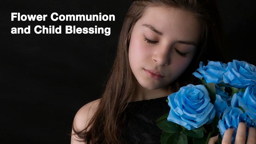 A girl holding blue colored flowers on a dark background