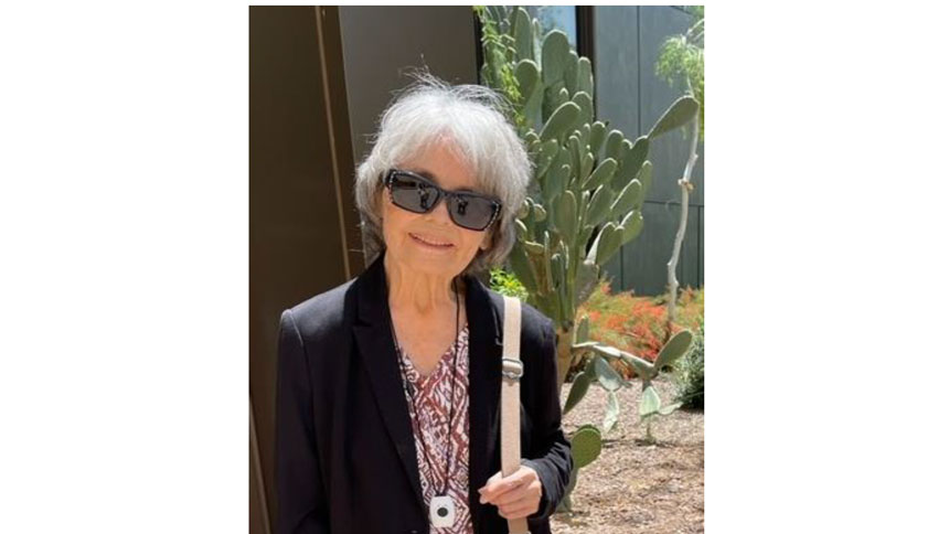 A picture of Sue Kennedy with some Cactus in the background.