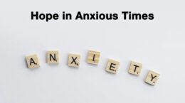 The words Hope in Anxious times in black over the word Anxiety spelled out with scrabble letters on a white background.