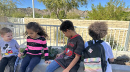 A group of kids sitting outside