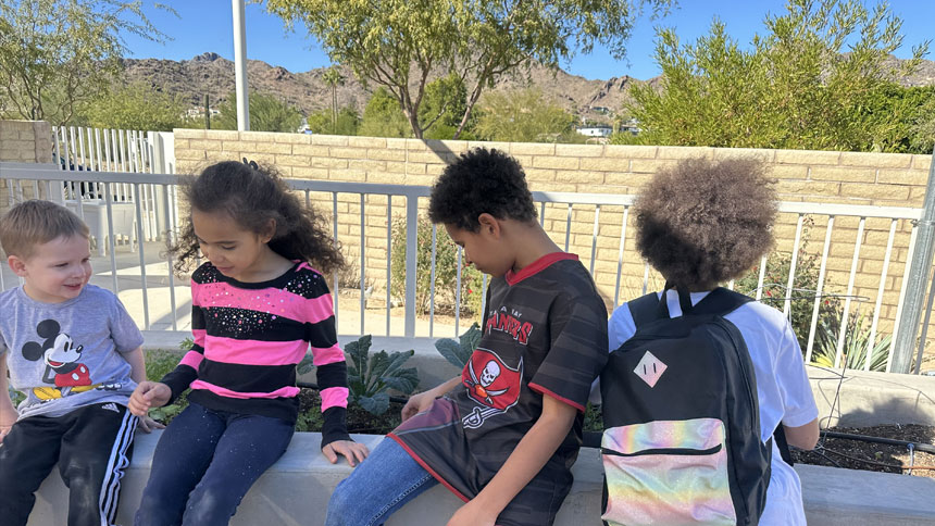 A group of kids sitting outside